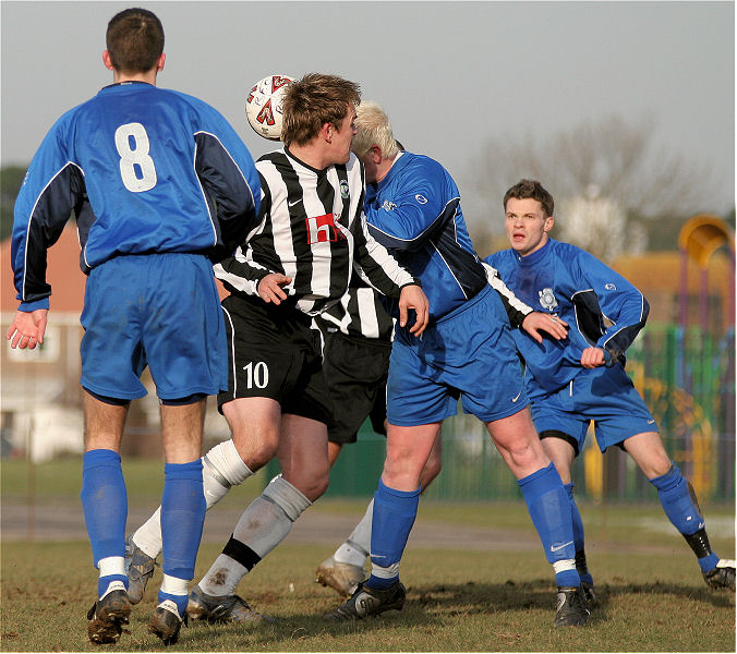 Russ Tomlinson beats Ryan Walton to a header watched by Adam Bibb and Ryan Morten
