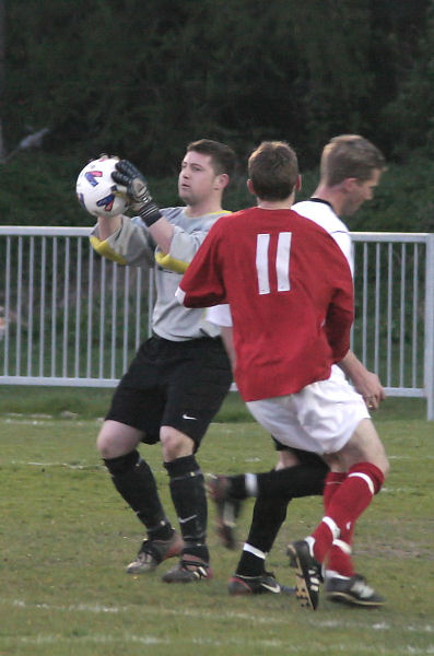 Southwick's Sam Figg grabs the ball before Andy Boxall (11) can reach it
