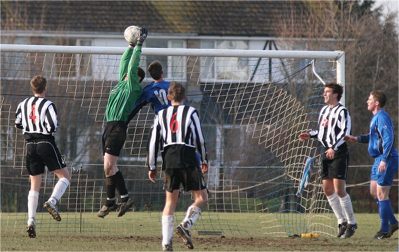 Keeper Simon Parsons gets to the ball before Mike Hatch
