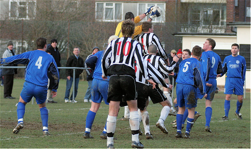 Andy McCarthy takes the ball off the head of Ashley Jones
