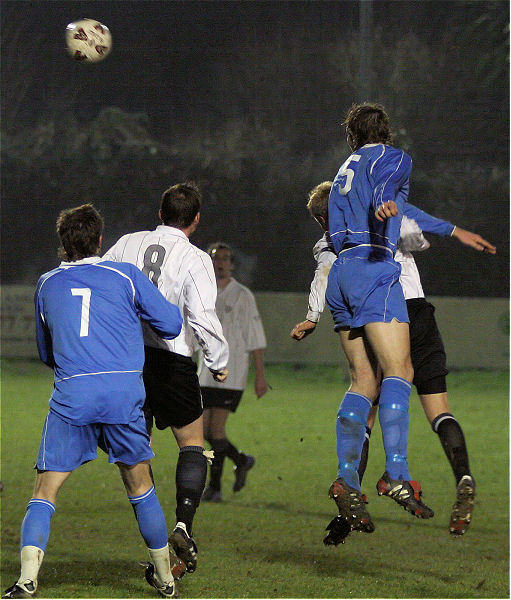 Danny Gainsford gets above Dave Hall for a header
