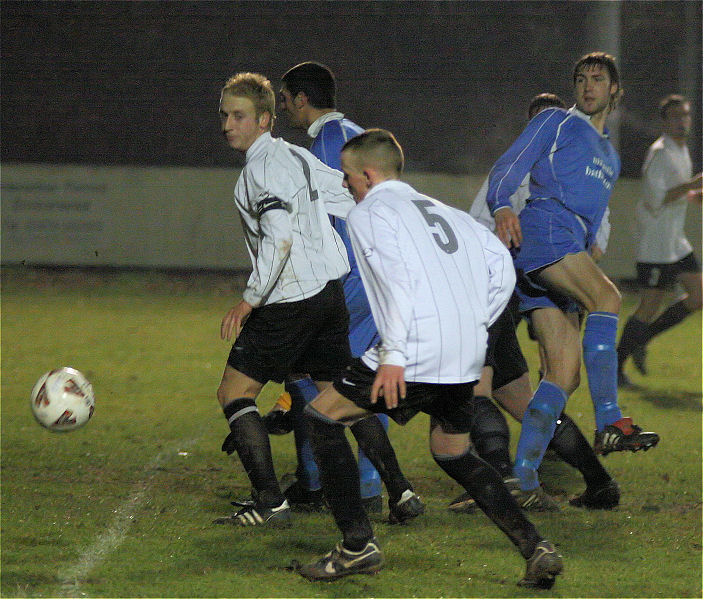 Dave Hall (2) and Alex Duncan (5) break up a Shoreham attack
