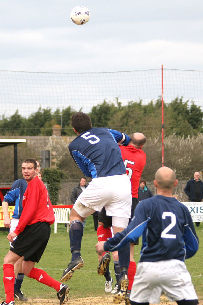 Captains Craig Bishop and Tony Miles compete for a header
