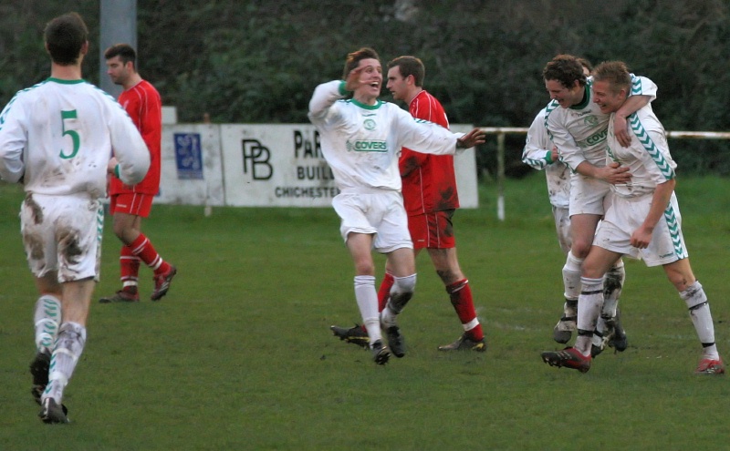 ... and the Chi players run to scorer Alex Ward
