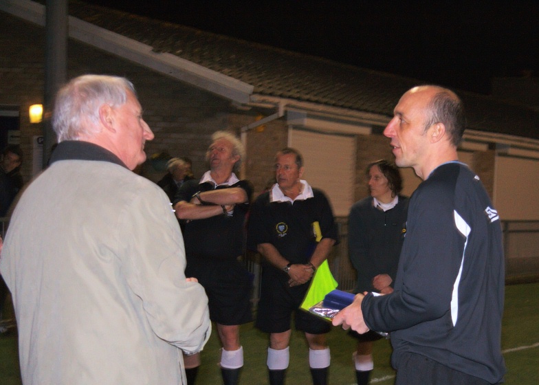 Mick Catlin collects his winning manager's award from Ray Lewis
