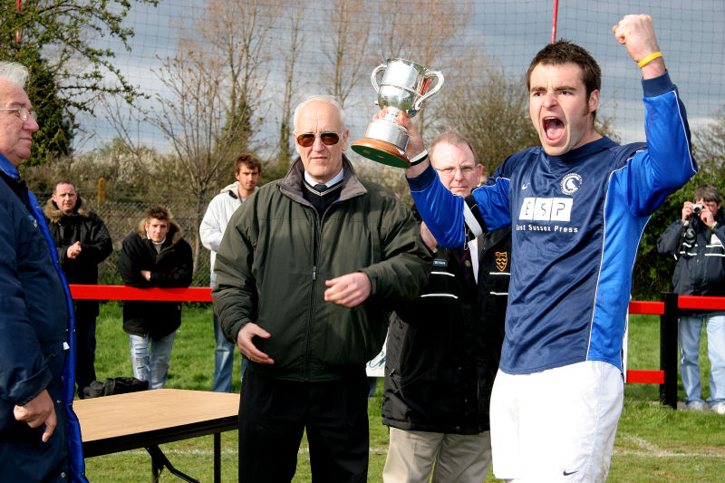 Crows captain Craig Bishop accepts the Championship Trophy from Peter Bentley
