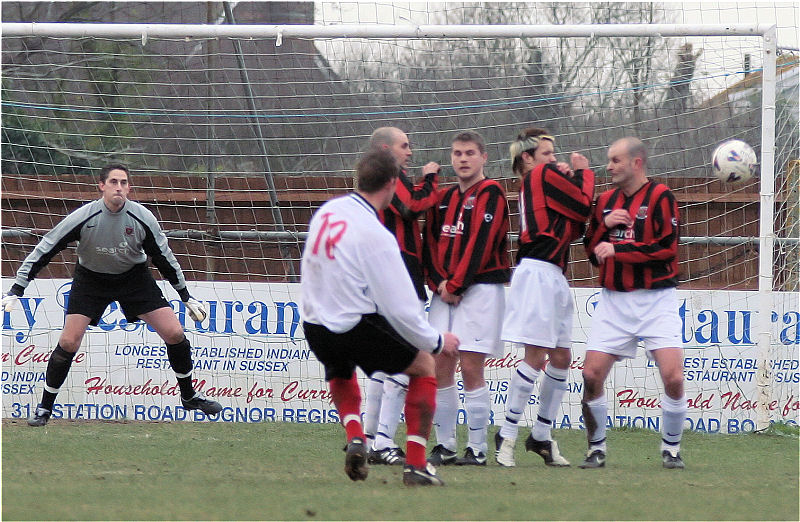 Brett Forden's free kick gets round the wall but comes back off the post
