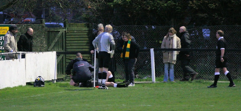 Concern as linesman Dave Huggett is struck by an object coming from outside the ground. Fortunately he was able to continue after treatment
