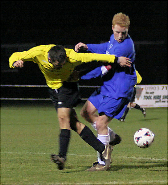 Rob Norris wins the ball from Darren Akmenkalns
