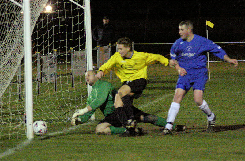 The ball comes off defender Andy Long ...
