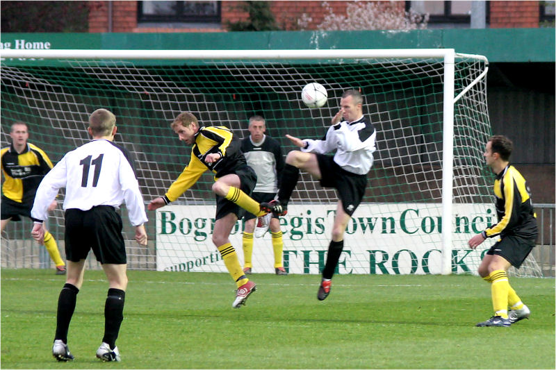 Chris Simmons heads clear watched by Matt Hoyte
