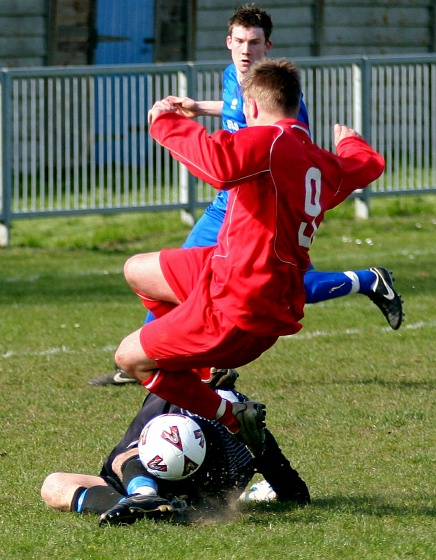 Adam Laundon saves at the feet of Ross Newman
