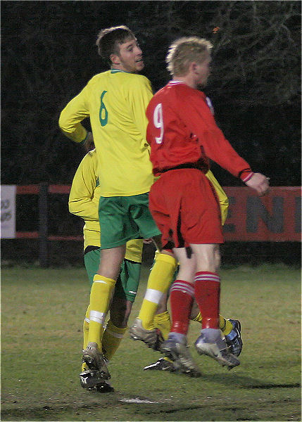 Danny Jones (6) and Mark Saunders (9) jump for a header
