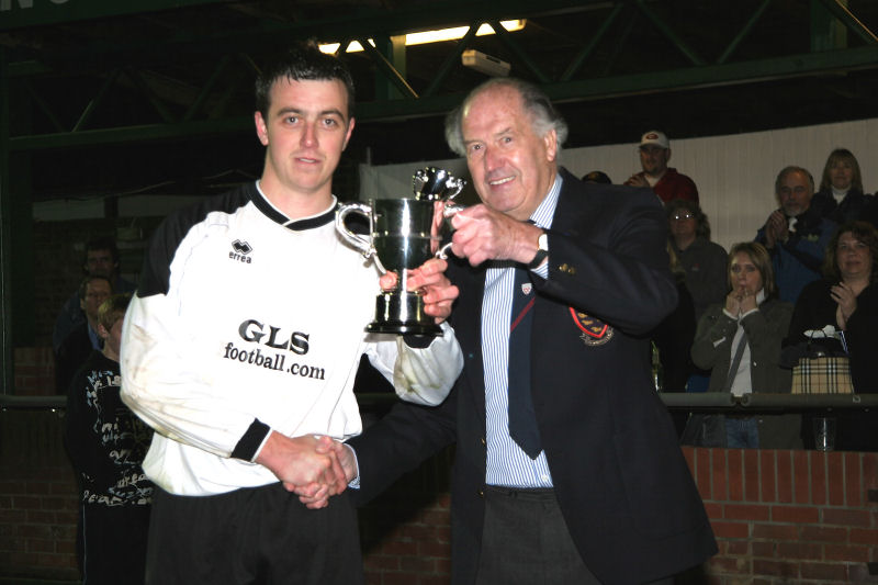 Loxwood captain Matthew Boxall receives the cup from Mr Peter Wilkins
