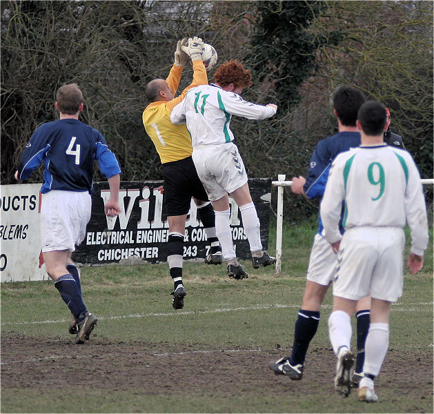 Kush Moffavagh grabs the ball under a strong challenge from James Smith
