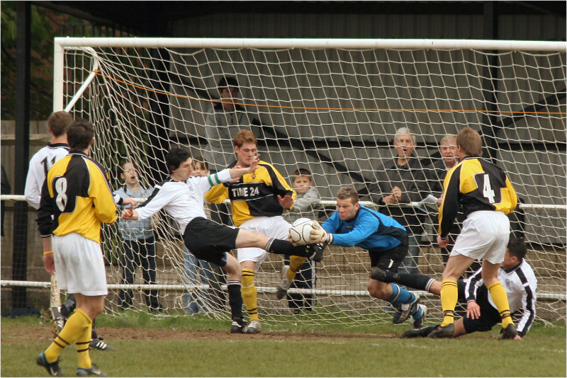 Keeper John Sullivan grabs the ball from the foot of Molesey captain Paul Gower
