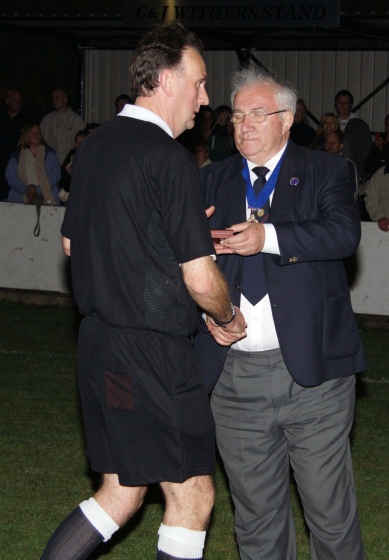 Referee Paul Hammond receives his memento
