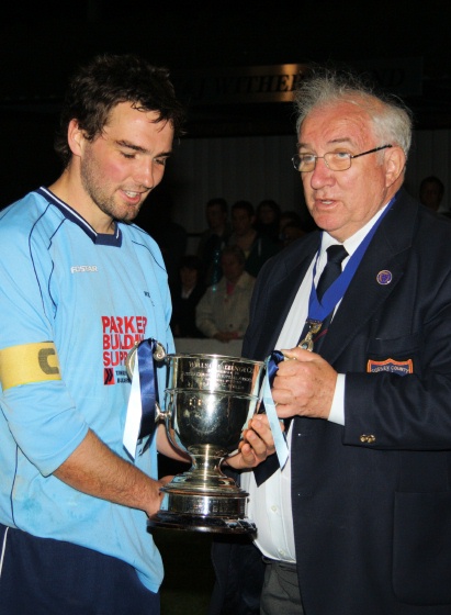 Wealden captain Chris Morrow receives the cup from Peter Bentley
