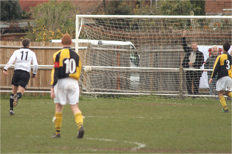 Burgess Hill captain Leo Day (10) looks on helpless as the ball bulges the netting ...
