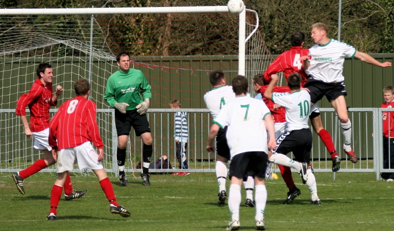 Alex Ward gets a header under pressure from Dave Walker
