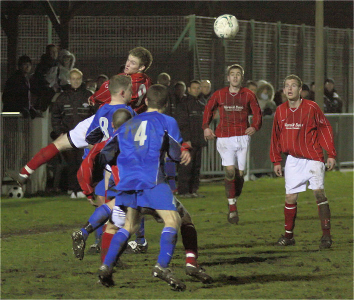 Both sides scramble for the ball near the touchline
