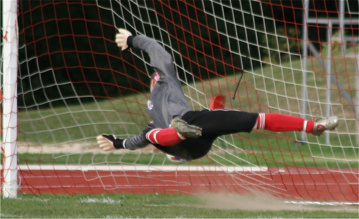 Penalty to Guildford City and Dan Kelton goes the right way but it's just out of reach
