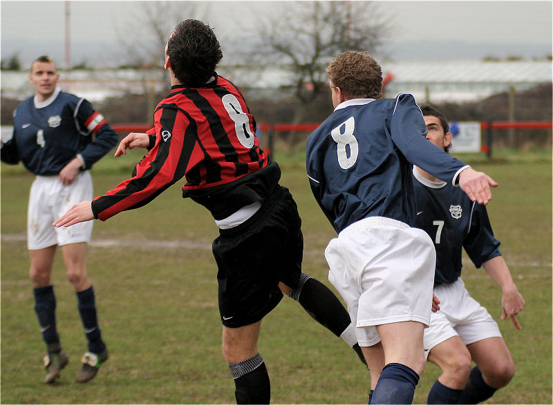 Marc Cooper and Simon Clayton go for a header
