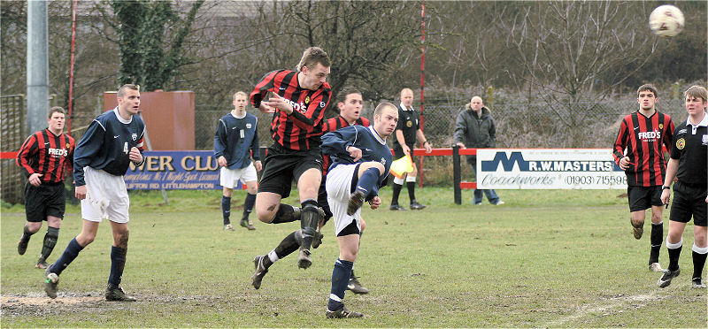 Mike Duffell heads away from Matt Huckett
