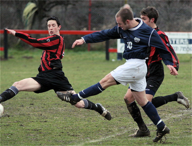 Dave Sharman gets across as Matt Huckett fires a shot
