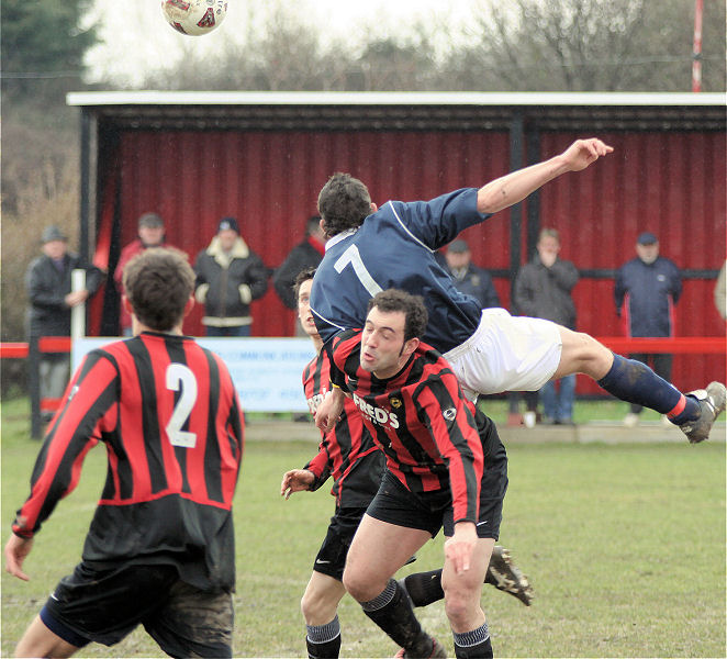 Jason Wimbleton (7) gets between Dave Sharman and Pete Christodoulou
