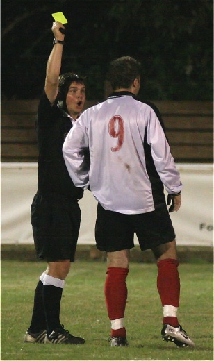 Rob Wimble is booked by referee David Spain
