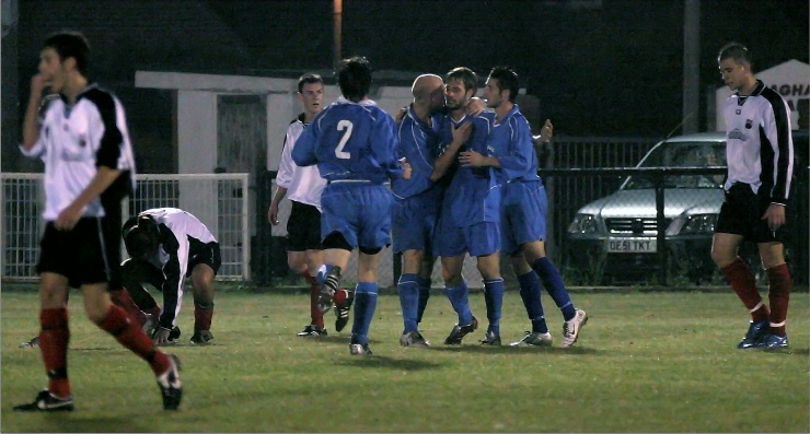 Marcus Farrell is congratulated on opening the scoring for Shoreham just before half time
