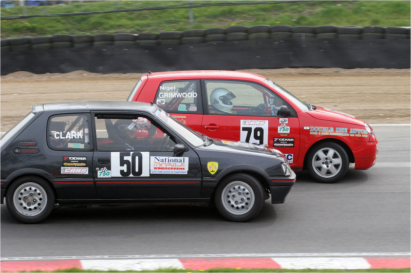 Nick Clark in the Peugeot 205 GTi (50) squeezes inside Nigel Grimwood's VW Lupo (79) at Druid's
