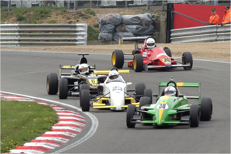 Peter Denham (38) gets his Vauxhall Lotus a bit out of shape ahead of Nick Barnett (23), David Longstaff (6) and Kelvin Laidlaw (74)
