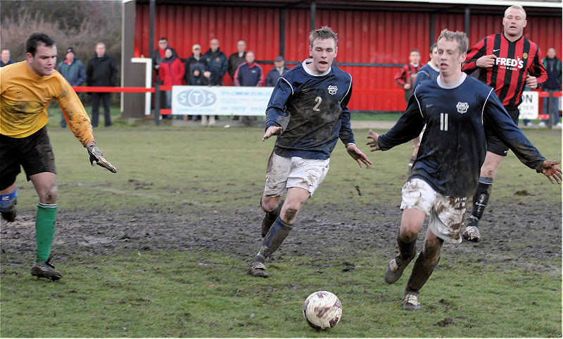 Lee Barnard (2) and Mike Huckett (11) shield the ball out of play
