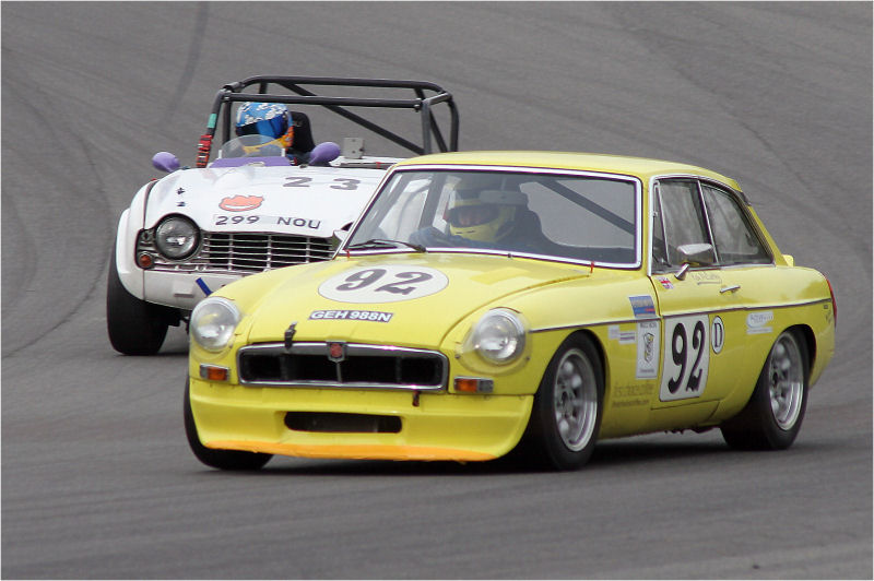 Race winner Roy McCarthy (92) MGB GTV8 and John Ellison (23) Triumph TR4 go hrough Clearways
