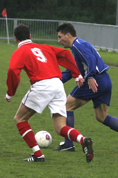 Terry Withers takes the ball past Leon Barnett (9)
