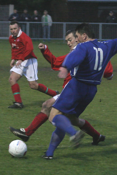 Terry Withers (11) crosses under pressure from Paul Sumnall
