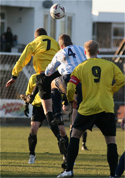 Phil Turner (7) and Mike McCaffrey(4) jump for a header
