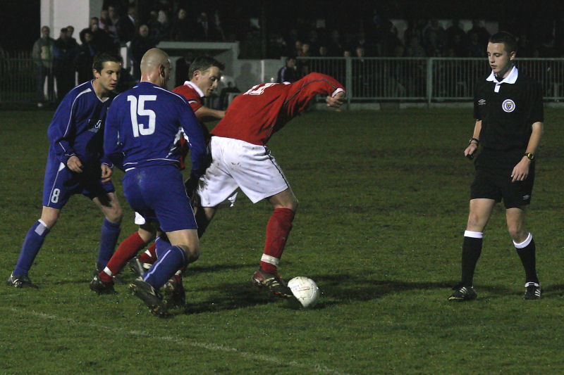 Bosham captain Andy Probee and John Thompson get the ball away from Benn Challen (8) and Chris Hooker (15) with referee Ashley Slaughter close to the action
