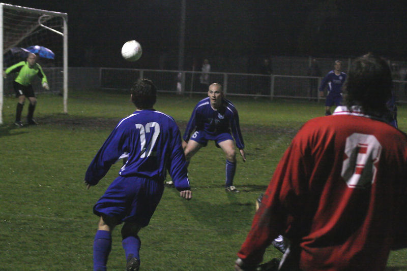 Bradley Miles (8) watches the ball slung across the Rustington goalmouth beating Dave Oakes (12) and Chris Hooker (15) 
