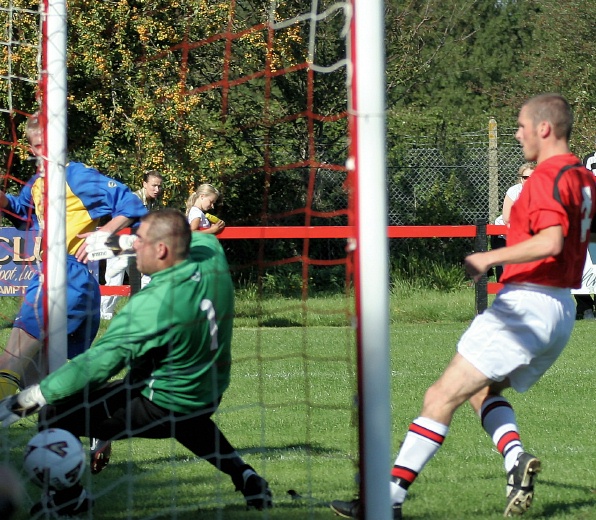 Barry Leete squeezes the ball past Wes Hallett to put Lancing 1-0 up on 15 minutes
