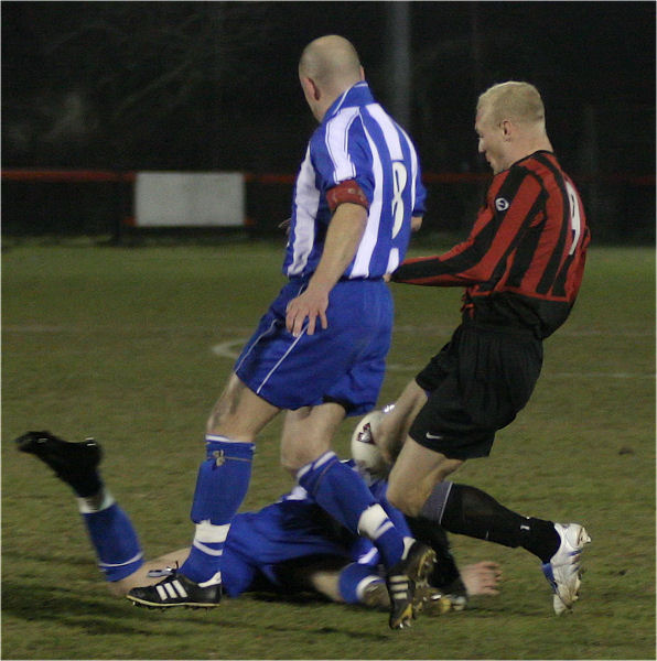 Daren Pearce and Kane Evans compete to take the ball off of the back of Danny Fuller
