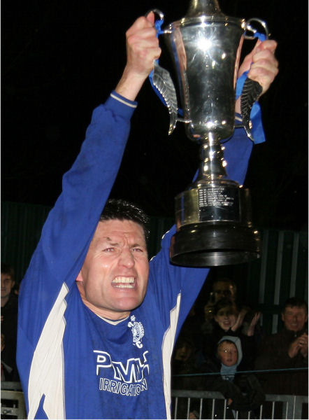 Terry Withers raises the Sussex Intermediate Challenge Cup, Rustington's THIRD trophy this season.
