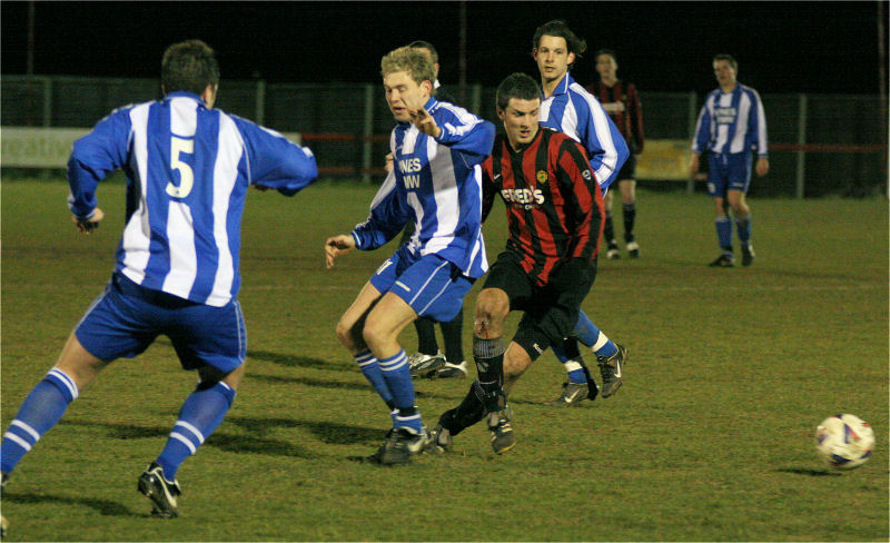 Tom Manton goes round Danny Wackett and Gary Bidwell
