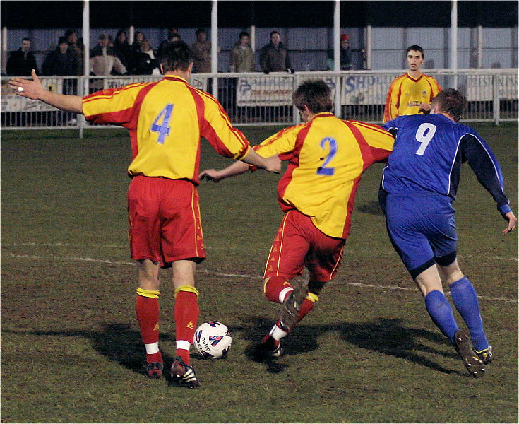 Jason Tighe (4) and Scott Edwards (2) get the ball away from Andy Smart (9)
