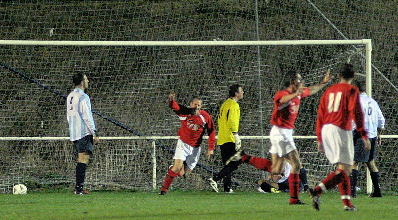 Mike Huckett (centre) celebrates opening the scoring for Arundel
