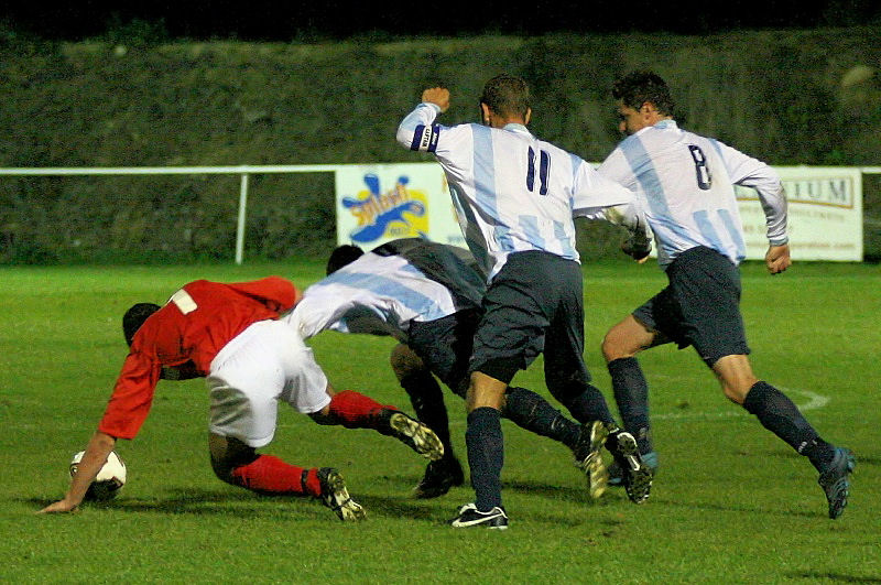 Jason Wimbleton tangles with Richard Maymon with Colin Moss (11) and Steve Webb (8) following up
