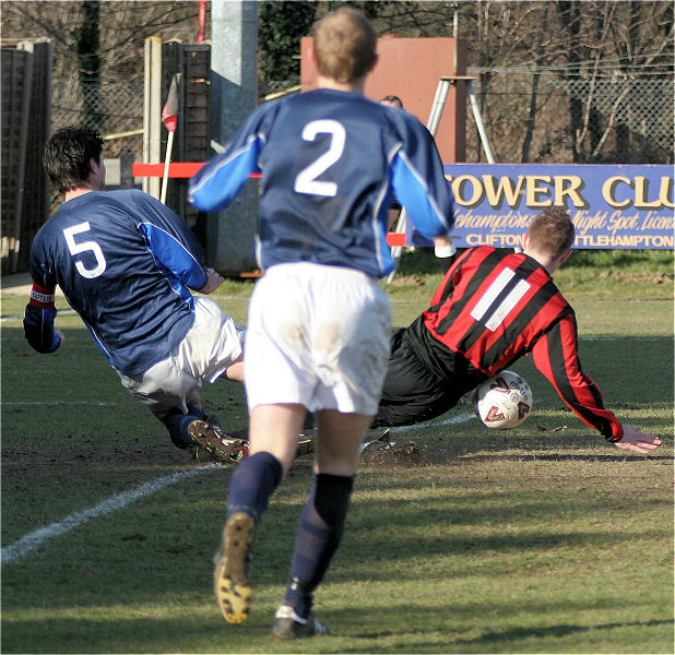 Nathan Godden (5) tackles Danny Curd (11) watched by Andrew Crush (2)
