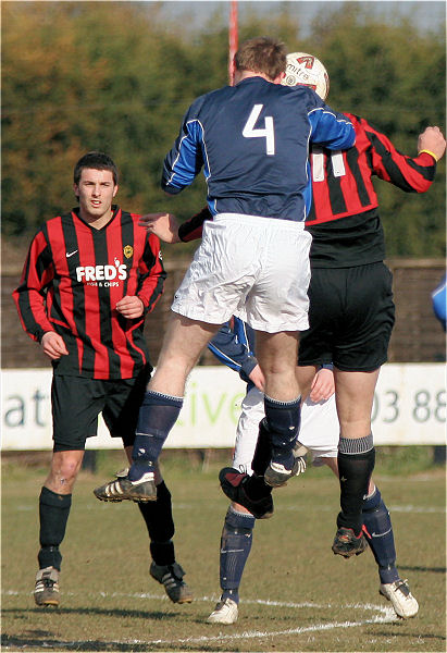 Phil Rhodes (4) and Pete Christodoulou go up for a header
